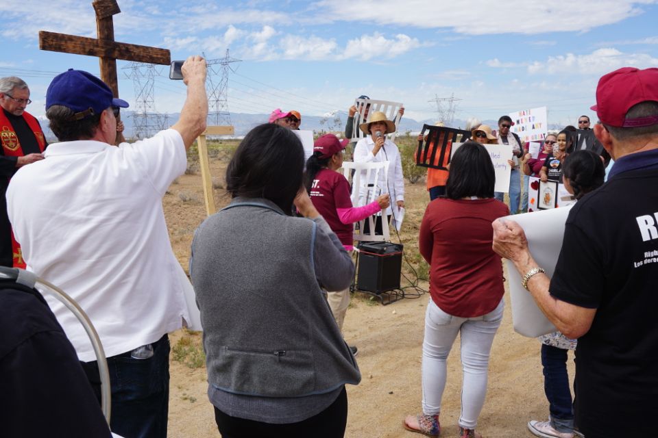 Hilda Cruz speaks to a group gathered for immigrant Stations of the Cross outside the Adelanto Detention Facility in California on Good Friday, April 19. (Photo by Marge Bitetti)